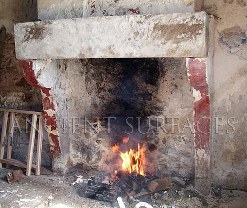 An Antique Stone Fireplace with 3 Layers of Paint, Missing its Top Shelf.