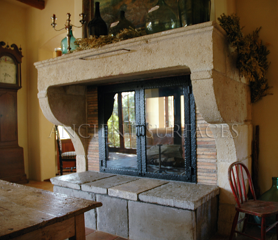 Installed ancient fireplace mantle in a French Provance style home