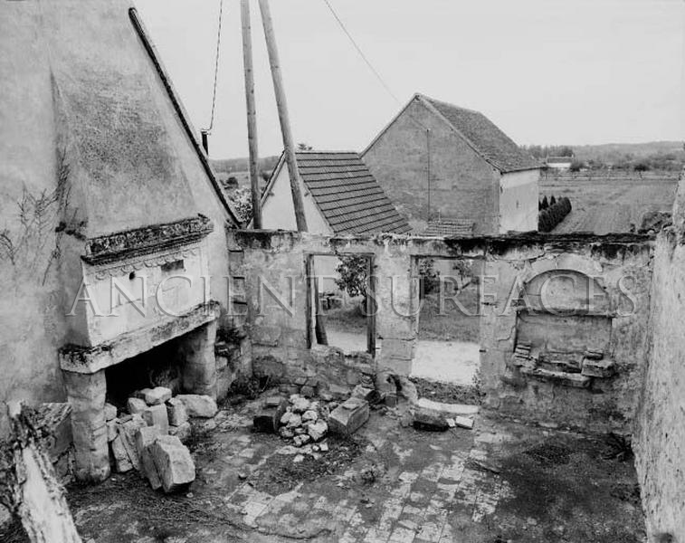 Antique countryside stone fireplace mantel in a ruinned Provence farmhouse photographed in the late 1940's