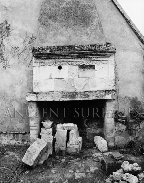 Antique countryside stone fireplace mantel in a ruined Provence farmhouse photographed in the late 1940's