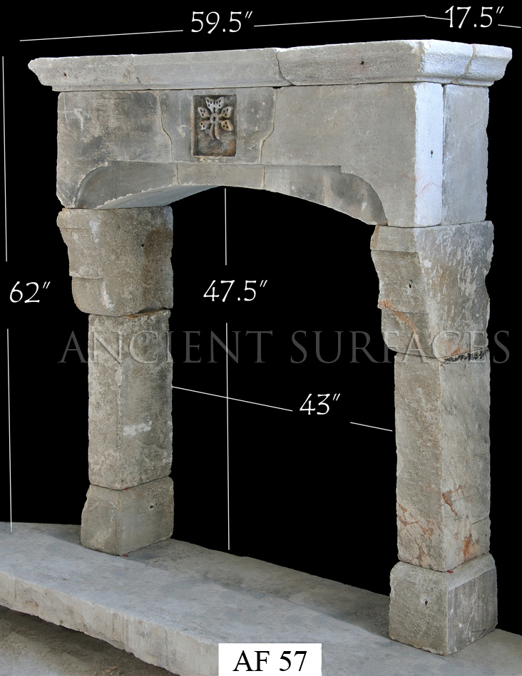 An antique reclaimed Tudor Gothic fireplace mantle by Ancient Surfaces