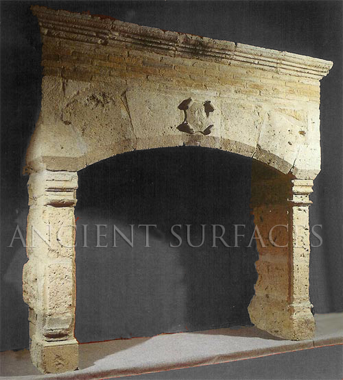 An antique reclaimed Norman era stone fireplace mantel
