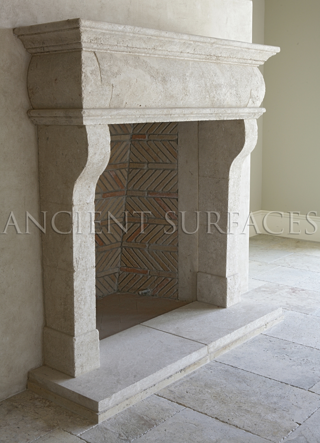 This Italian countryside fireplace was hand carved out of hard limestone installed with an interesting herringbone firebox and running bond brick lines.