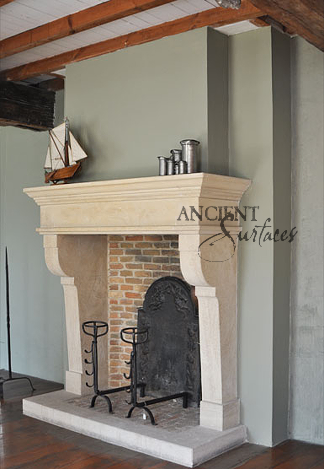This simple limestone carved fireplace is Tuscan in design installed with a thick stone hearth ad terracotta bricks. Running bond brick are inlay inside the firebox.