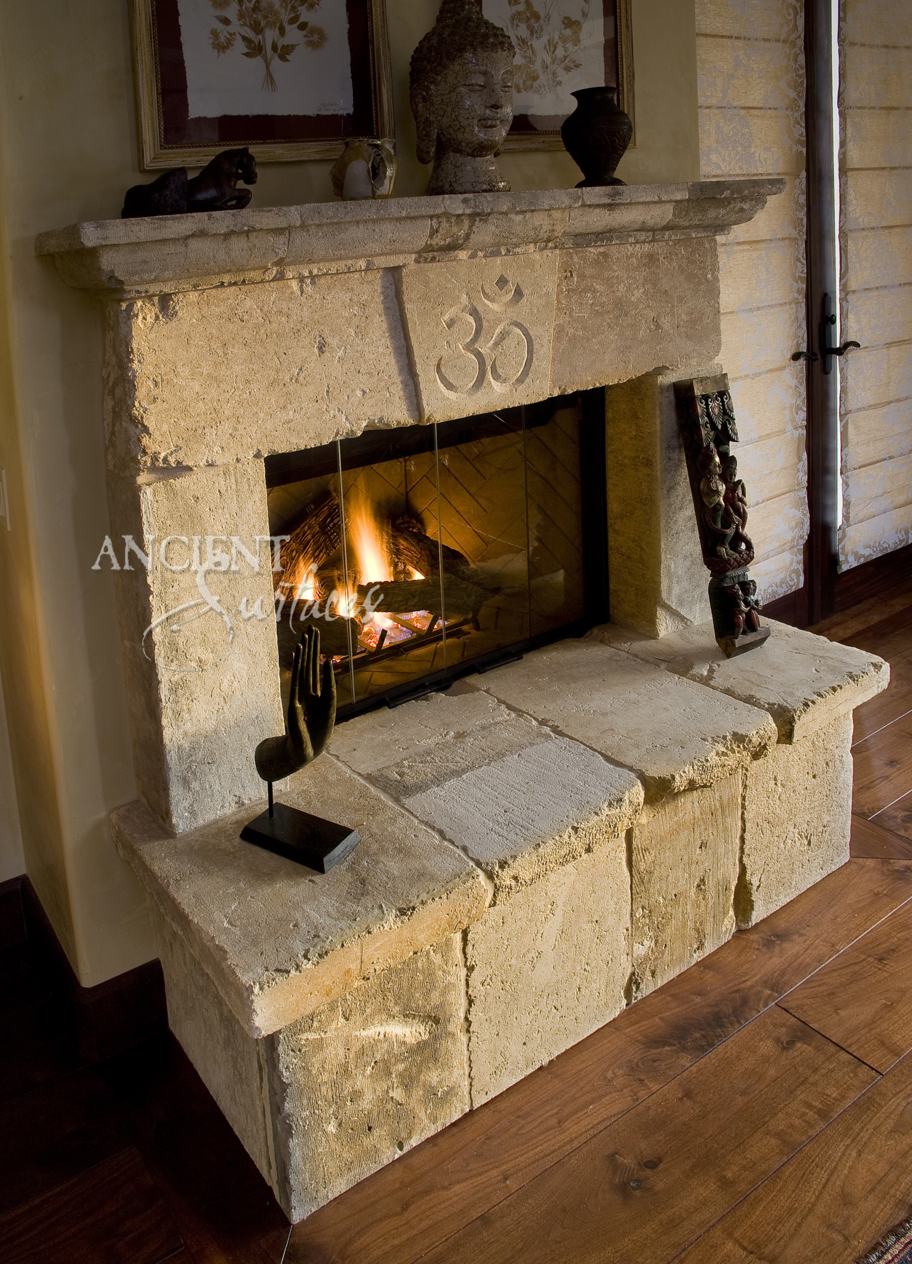 A simple Antique Old World Stone Fireplaces, with the Om yoga sign carved and etched on the center of its keystone by Ancient Surfaces