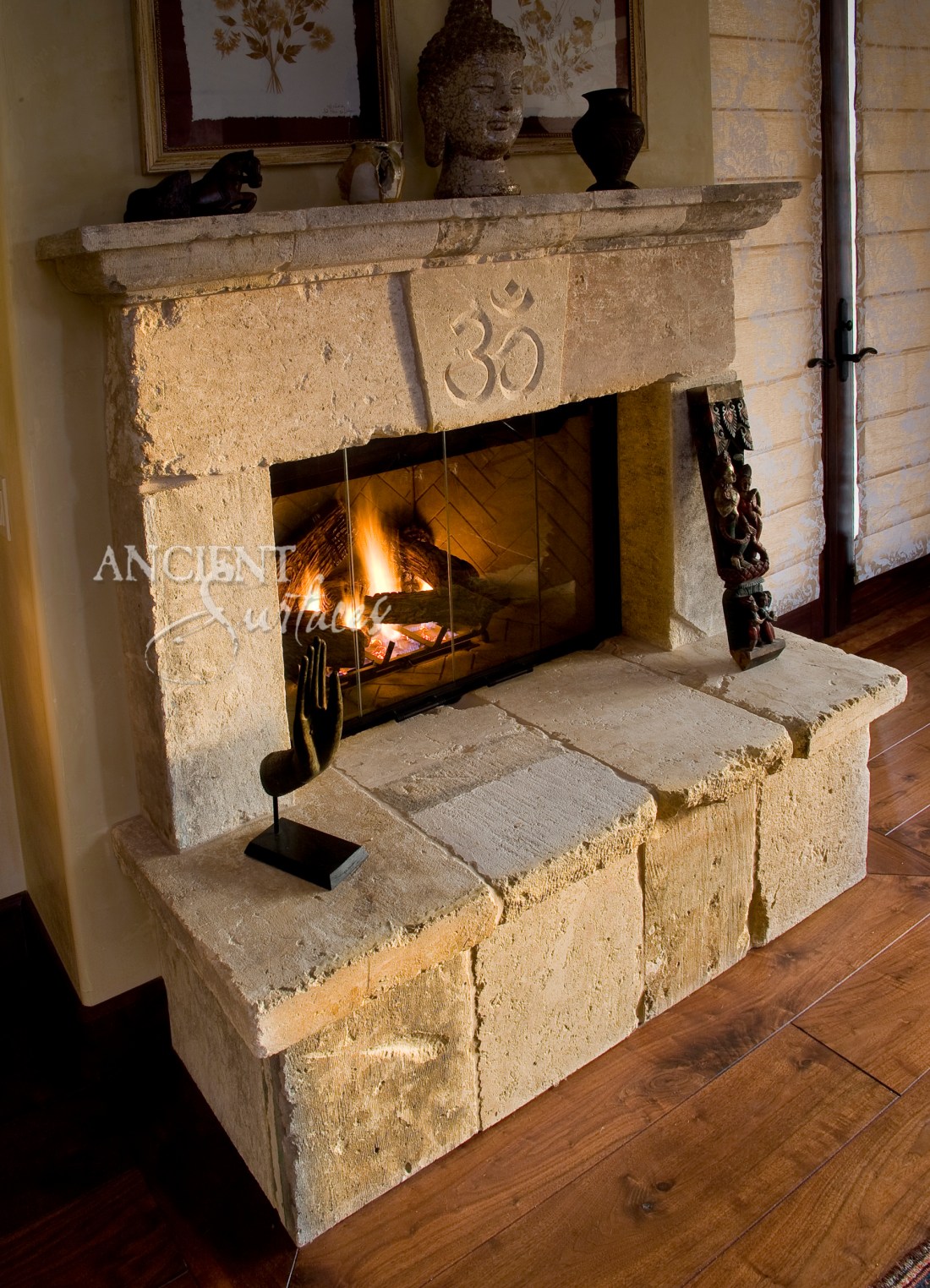 A simple Antique Old World Stone Fireplaces, with the Om yoga sign carved and etched on the center of its keystone by Ancient Surfaces