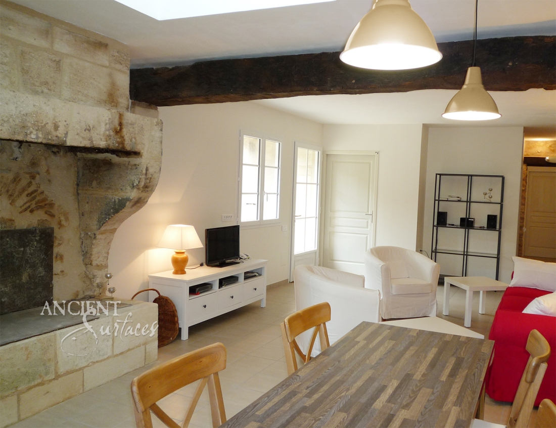 French Limestone Fireplace Mantle with Trumeau by Ancient Surfaces in a Renovated Countryside Vacation House