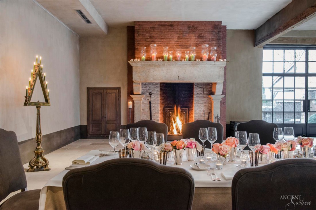 Beautiful-dining-room-with-majestic-antique-limestone-fireplace