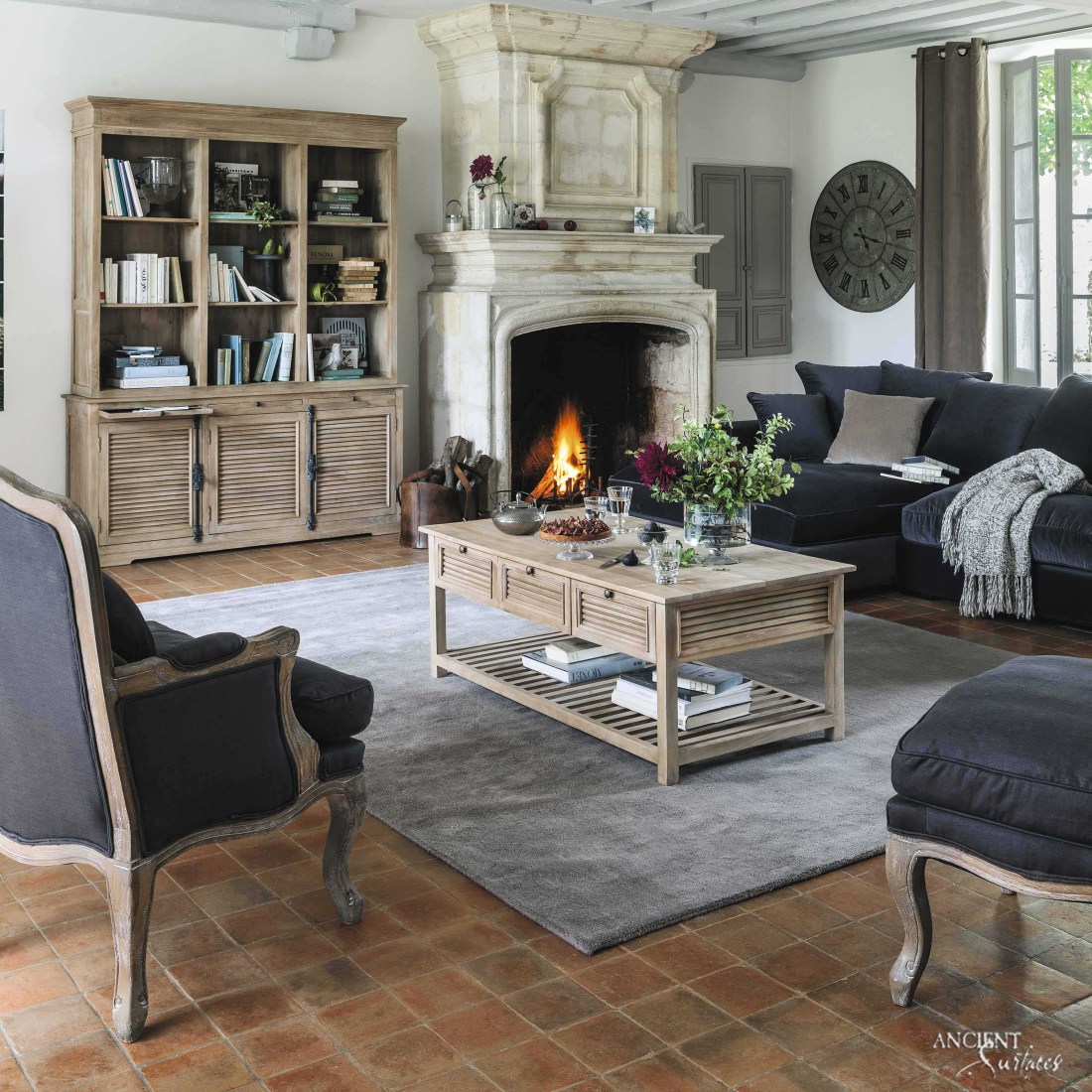 modern-living-room-area-with-a-relcimaed-antique-limestone-fireplace