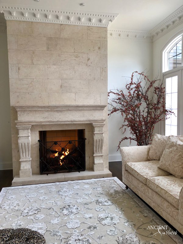 Close-up of the detailed work on a limestone fireplace, showcasing the passion and artistry of Ancient Surfaces