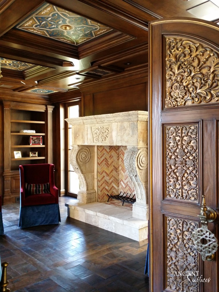 Elegant living room interior, dominated by a grand limestone fireplace, its mantle reflecting the intricate craftsmanship of Ancient Surfaces