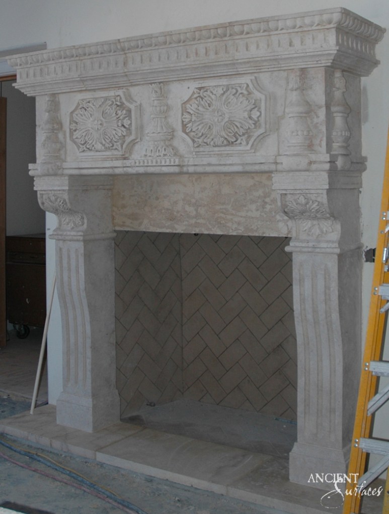 The intimate warmth of an indoor fireplace, its ancient stones surrounding a modern firebox, offering a serene spot for relaxation and reflection.